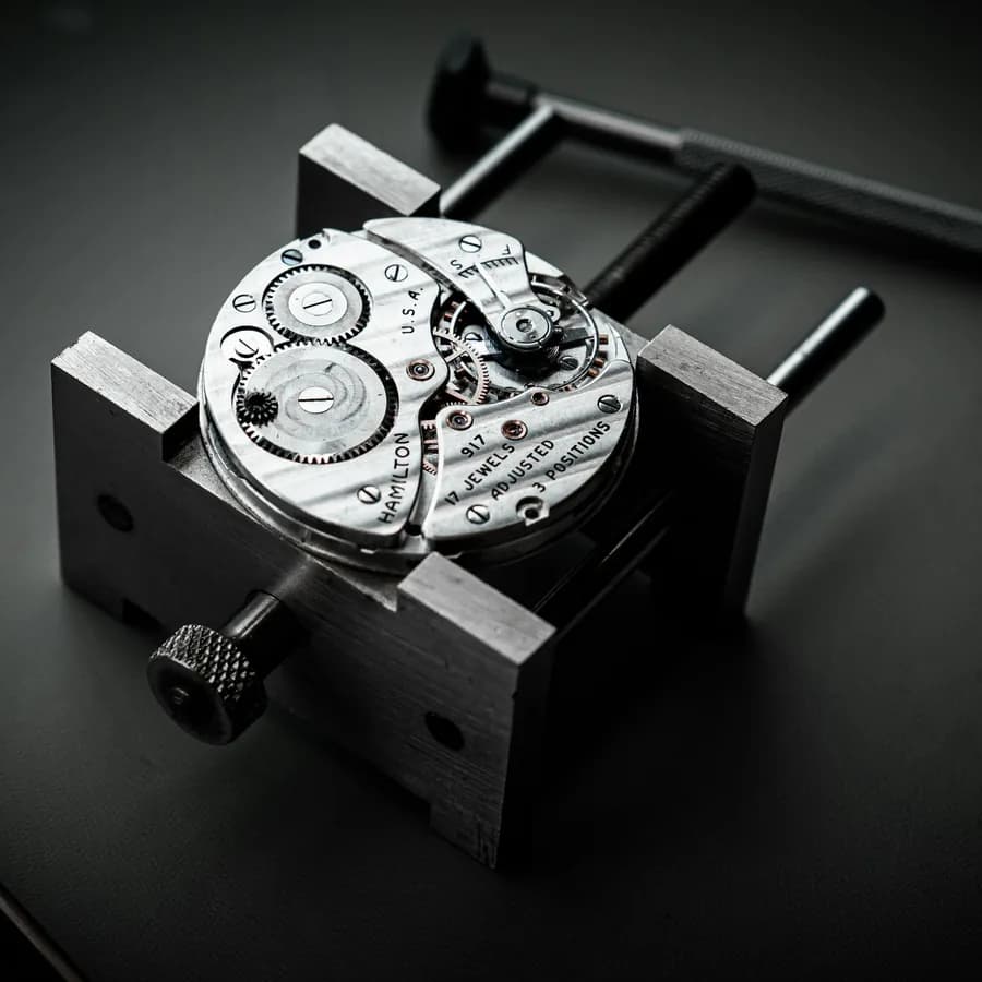 Mouvement mécanique de montre fixé sur un porte-mouvement d'atelier